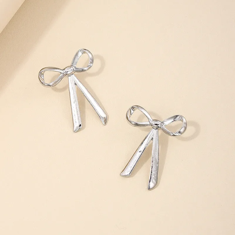 Exaggerated Metal Ribbon Knot Earrings with a Touch of Vienna Glam