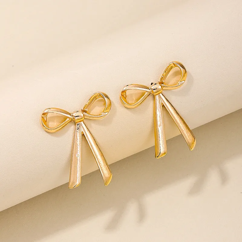 Exaggerated Metal Ribbon Knot Earrings with a Touch of Vienna Glam